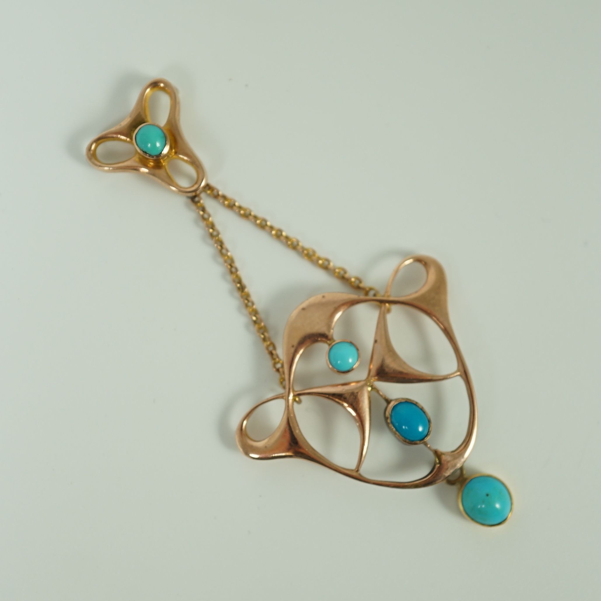 An Edwardian Art Nouveau 9ct gold and turquoise set drop pendant
